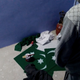 Shahid looking at the Pakistani flags made by him.